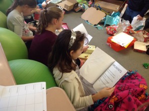 Students read the stories contained in their "Boxes of Hope"